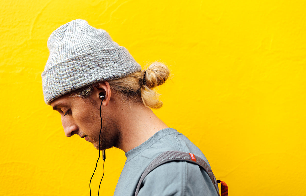 Man wearing earplug headphones
